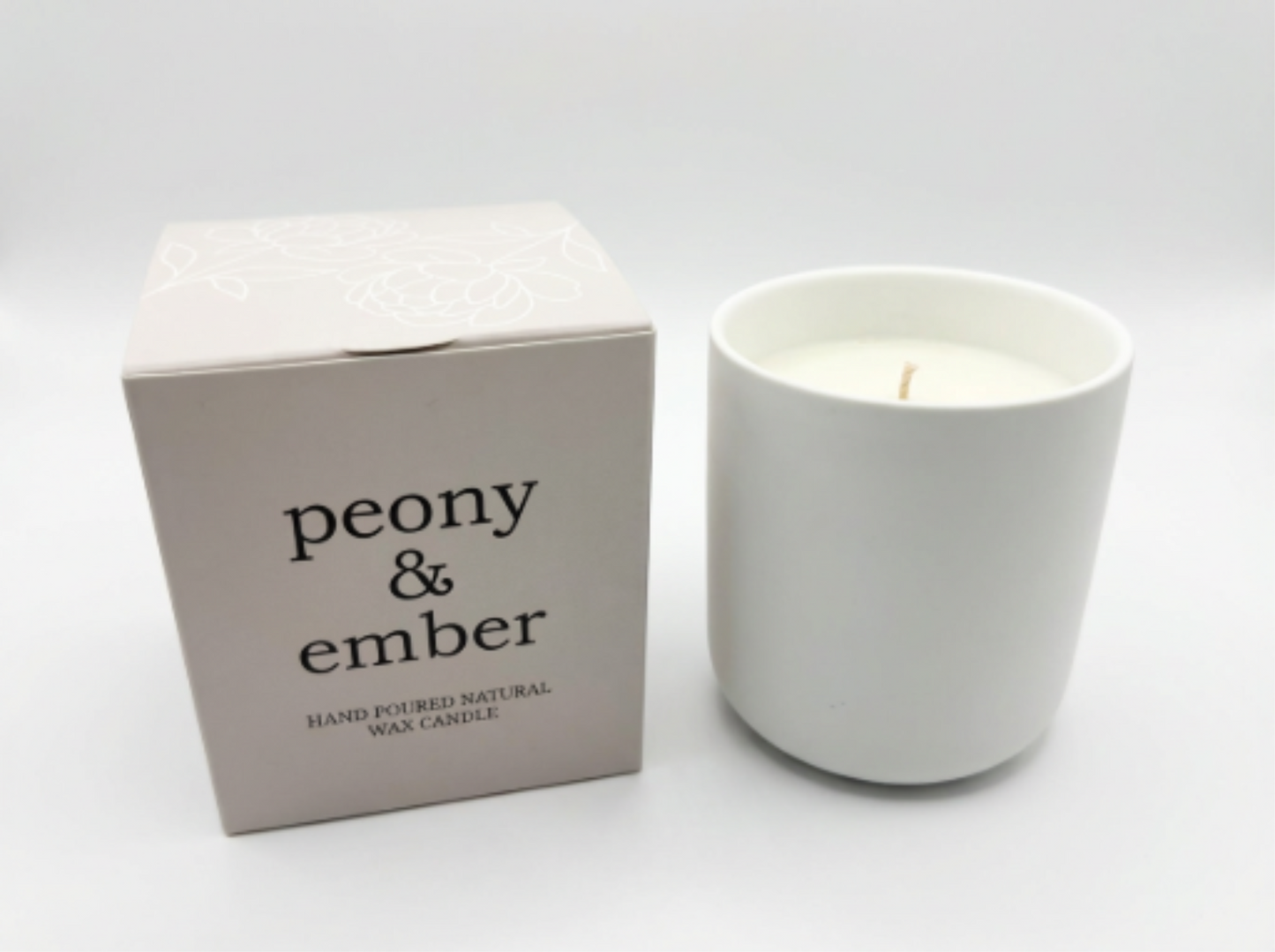 Single white ceramic candle vessel filled with natural vegan wax with with 'peony & ember' packaging on a white backgrround.