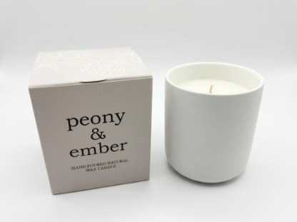 Single white ceramic candle vessel filled with natural vegan wax with with 'peony & ember' packaging on a white backgrround.