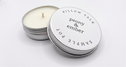 Candle sample in a tin labelled 'Pillow Talk' with the brand name 'Peony & Ember' in the middle on a white background